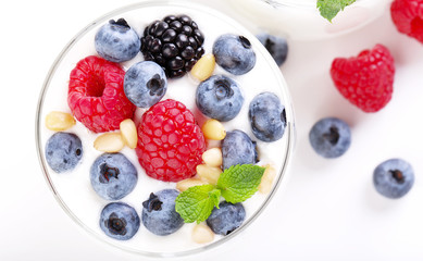 Two glasses of white yogurt with wild berries