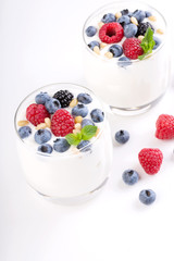 Two glasses of white yogurt with wild berries