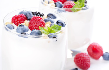 Two glasses of white yogurt with wild berries