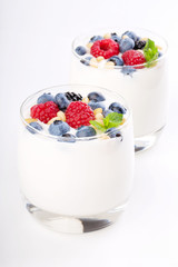 Two glasses of white yogurt with wild berries