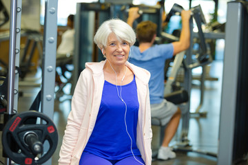 Fototapeta premium happy senior woman exercising at fitness center