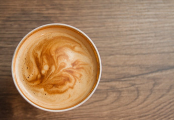 Coffee cup on wooden table, selective focus, copy space