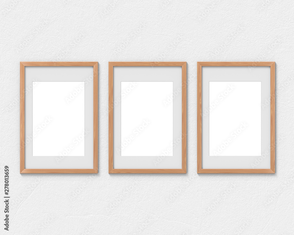Fototapete set of 3 vertical wooden frames mockup with a border hanging on the wall. empty base for picture or 