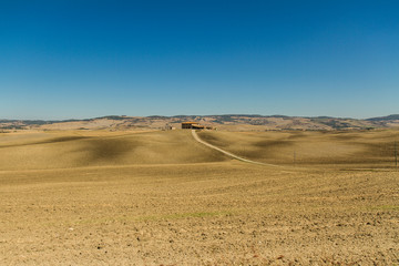 Fototapeta na wymiar panorama of Tuscan countryside with blue sky Italy