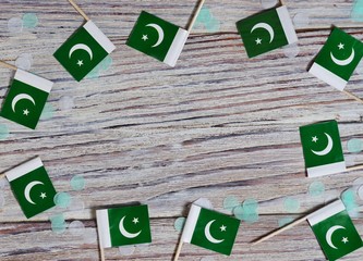 independence day of Pakistan. August 14. the concept of freedom, independence and patriotism. mini flags with confetti on wooden background. horizontal