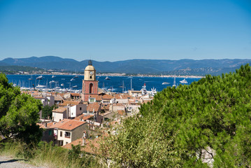 Panorama of Saint-Tropez, the roofs of houses, the chapel of St. Anne, the yacht in the bay. Commune in southeastern France in the region of Provence, Alpes - Cote d'Azur, France