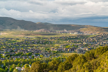 Residential area on a valley with view of distant mountain and cloudy blue sky