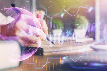Financial forex charts displayed on woman's hand taking notes background. Concept of research. Double exposure
