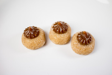 Sweetened condensed milk covered with sugar with drop of sweet creamy milk.