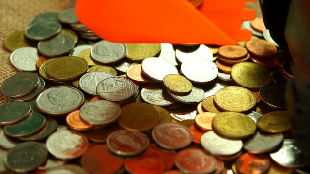 Toy backhoe  with pile of coin, in studio Chiangmai Thailand