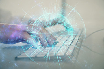 Double exposure of businessman working on laptop on background. International business hologram in front. Concept of success.