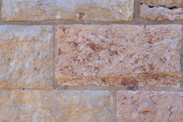 Texture of old ancient stone wall of a spanish church close up