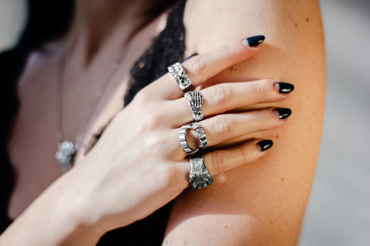 young woman with silver rings on hand