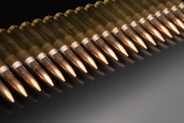 Bullet isolated on black background with reflexion. Rifle bullets close-up on black back....