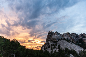 A dramatically colorful sky developing around sunset behind the four US presidents of Mount...