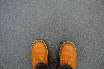Close-up of male legs in brown leather shoes