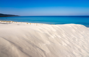 Fototapeta na wymiar White dunes of Is Arenas and blue sea in Sardinia