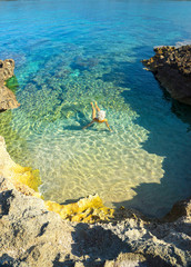 woman swimming in the clear water of the Sardina