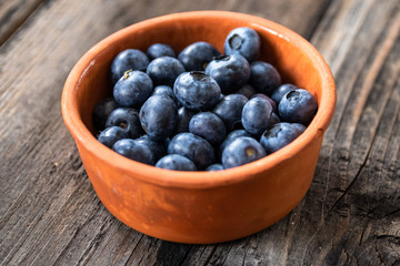 Fresh raw organic blueberries on vintage wooden table