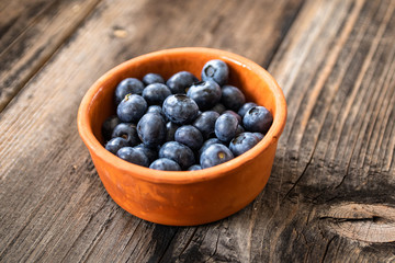 Fresh raw organic blueberries on vintage wooden table