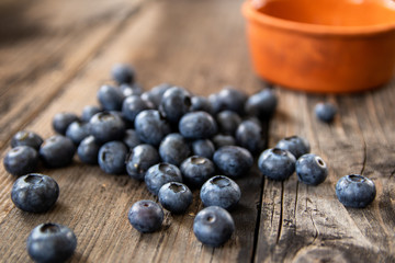 Fresh raw organic blueberries on vintage wooden table