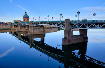 River side view of St-Pierre bridge crossing the Garonne early morning with clear reflection in river