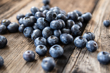 Fresh raw organic blueberries on vintage wooden table