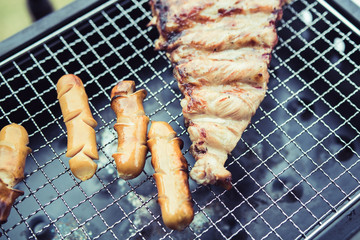 Close up grill with meat and sausage ready for socializing celebrate at outsite home.
