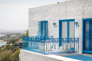 Sidi Bou Said, Tunisia - June.06, 2019: Alley with traditional white houses and blue doors.