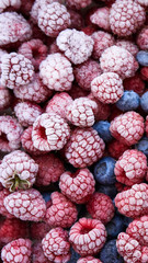 Background of frozen berries. Top view of raspberries and blueberries.