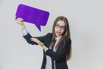 Young woman is holding a violet speech bubble over herself, which is rectangular-shaped, isolated,...