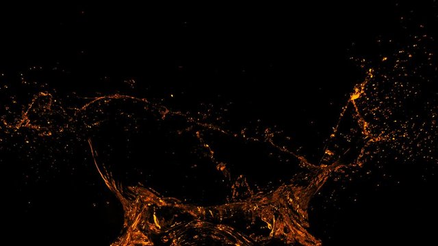 Super Slow Motion Shot of Golden Splash at 1000fps Isolated on Black Background.