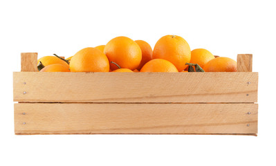 Ripe orange fruits in wooden crate isolated on white