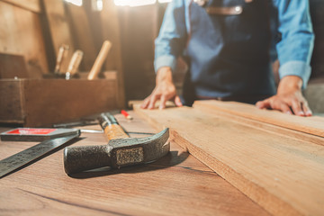 Carpenter on workplace in carpentry workshop.