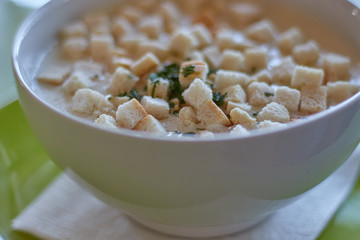Traditional Hungarian garlic soup with bread pieces in the restaurant