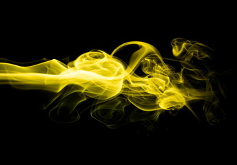 Yellow smoke on black background