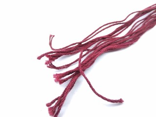 A picture of dark red rope isolated on white background