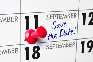 Wall calendar with a red pin - September 11