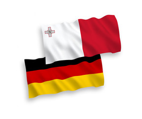 National vector fabric wave flags of Germany and Malta isolated on white background. 1 to 2 proportion.