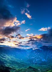 Montenegro, Blue sky and glowing clouds of colorful sunset sky over world famous ravine of tara river canyon from above at dawn in beautiful durmitor national park nature landscape near zabljak