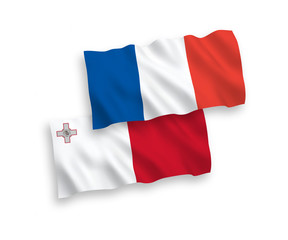 National vector fabric wave flags of France and Malta isolated on white background. 1 to 2 proportion.