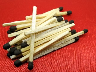 A picture of matchsticks isolated on red background