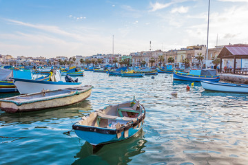 Fototapeta na wymiar Marsaxlokk with Luzzu, traditional fishing boat from Malta islands