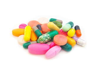 Heap of colorful  pills and drugs isolated on white background