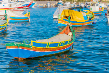 Fototapeta na wymiar Marsaxlokk with Luzzu, traditional fishing boat from Malta islands
