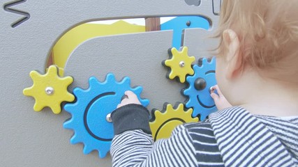 Child turns the gears