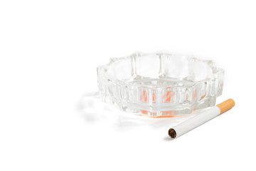 Cigarette and ashtray on white background