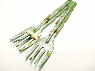A picture of rusted forks on white background
