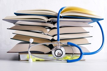 Medical knowledge. Pile of open books for medical student