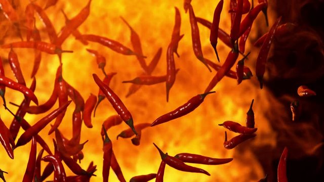 Super Slow Motion Shot of Falling Red Chilli Peppers to fire at 1000fps.